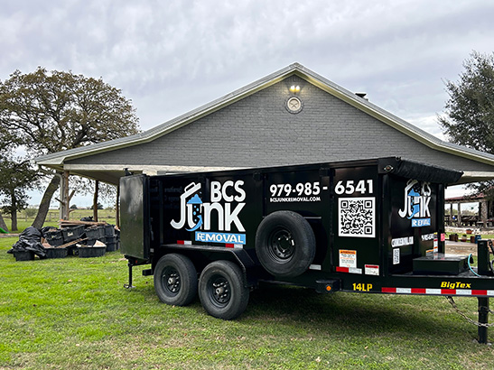 A dumpster and a junk removal truck side by side in College Station