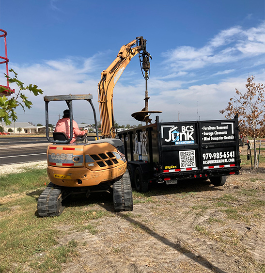Live load junk removal container being filled in College Station